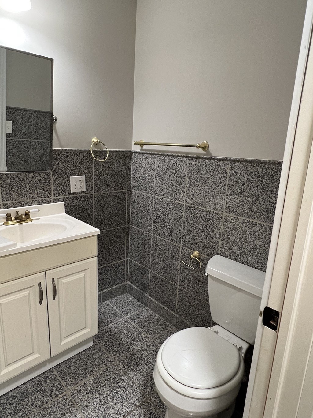 an empty bathroom with a toilet and a sink