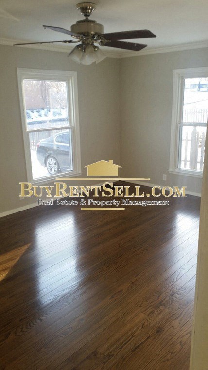 A room with a BuyRentSell.com logo on the wall.