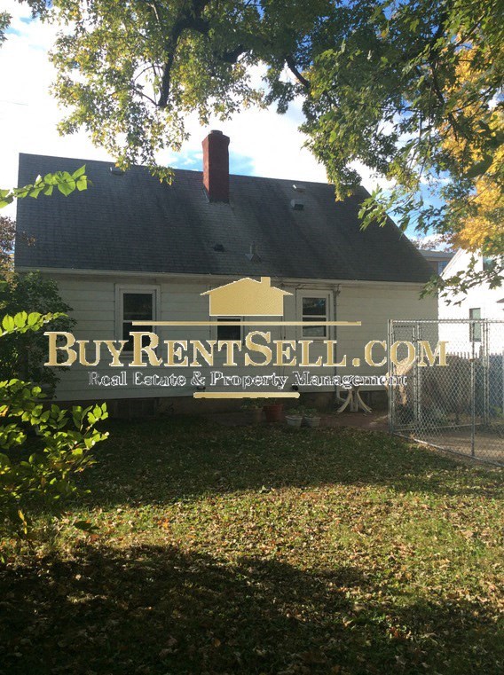 A house with a sign that says Buy Rent Sell.