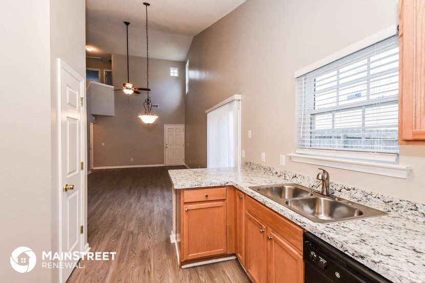 an empty kitchen with a sink and a window