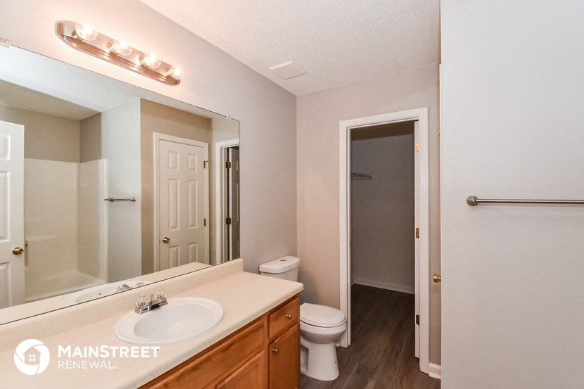 a bathroom with a sink and a mirror and a toilet