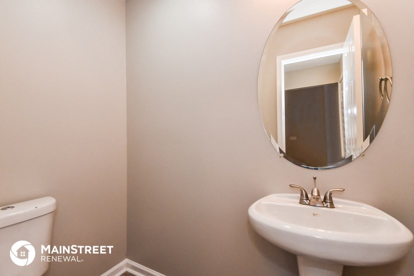 a bathroom with a sink and a mirror and a toilet