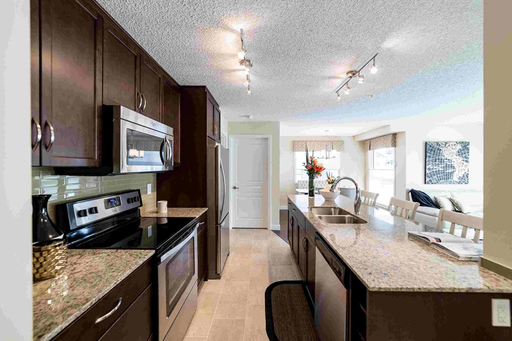 a kitchen with stainless steel appliances and granite counter tops