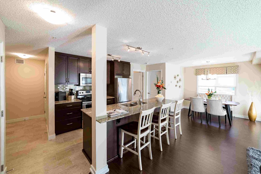 a kitchen and dining room with a table and chairs