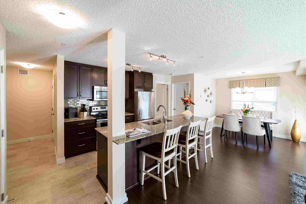 a kitchen and dining room with a table and chairs