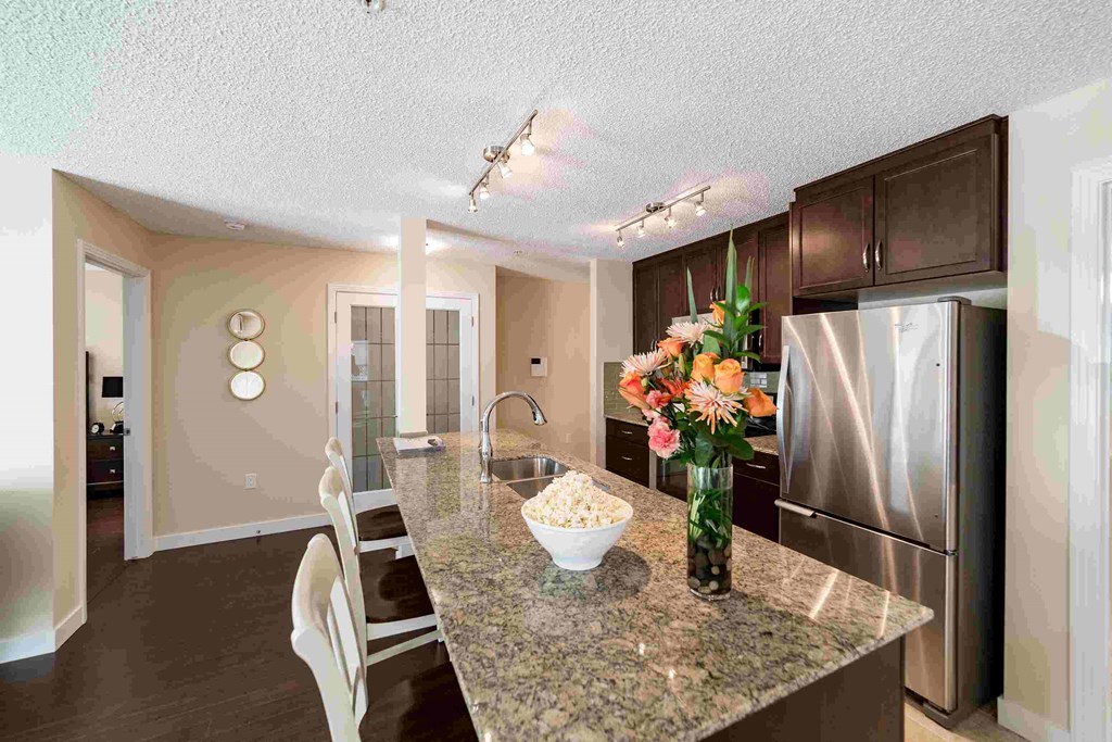 a kitchen with stainless steel appliances and a granite counter top