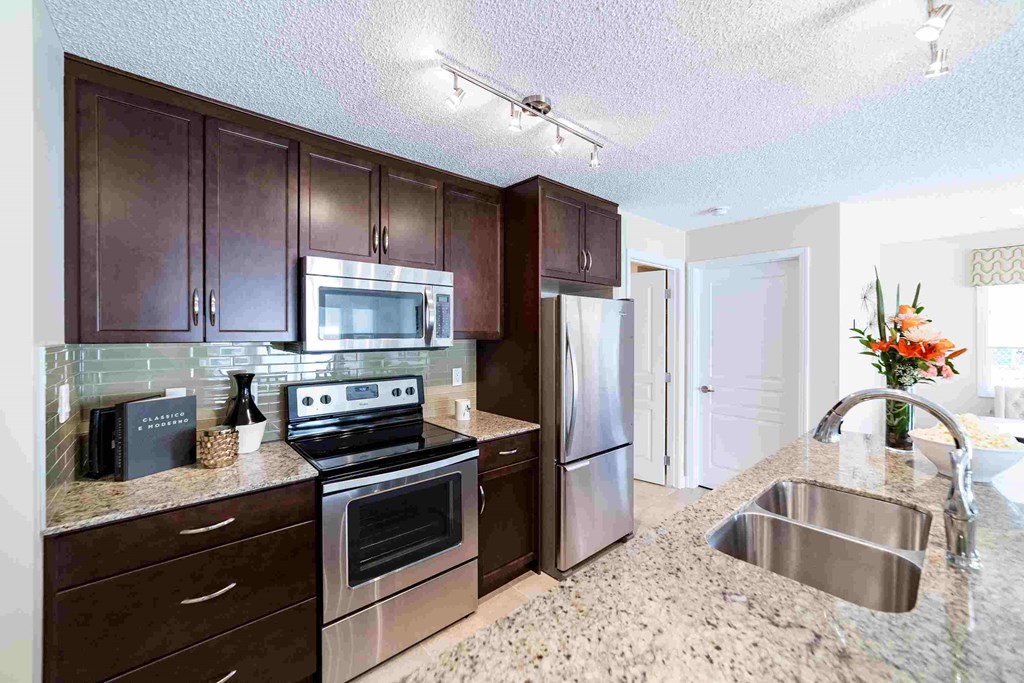a kitchen with stainless steel appliances and granite counter tops