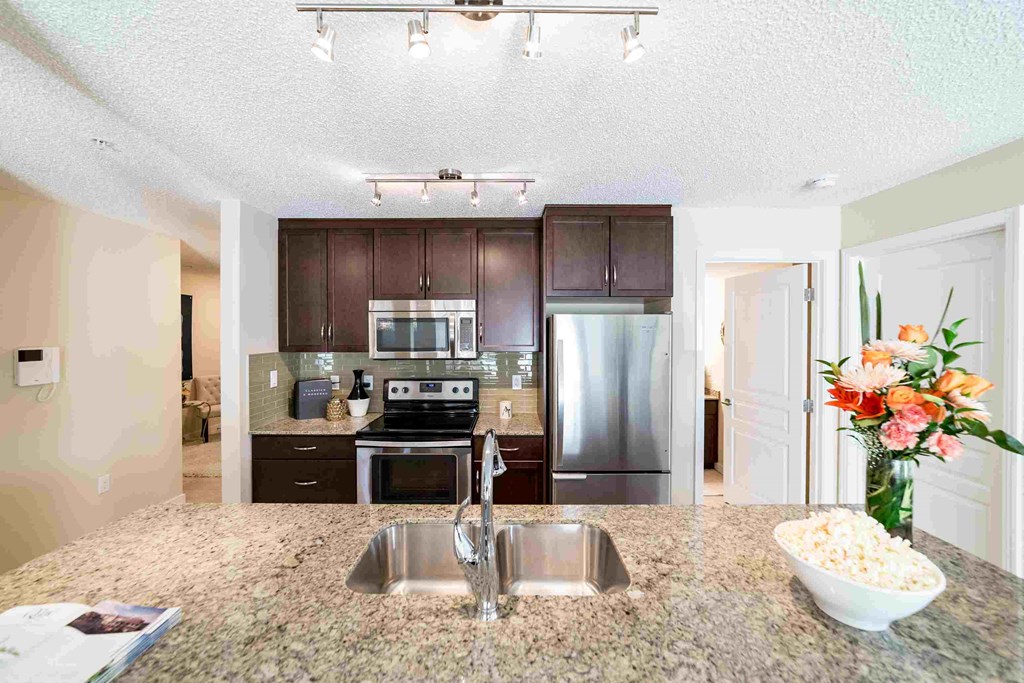 a kitchen with stainless steel appliances and granite counter tops