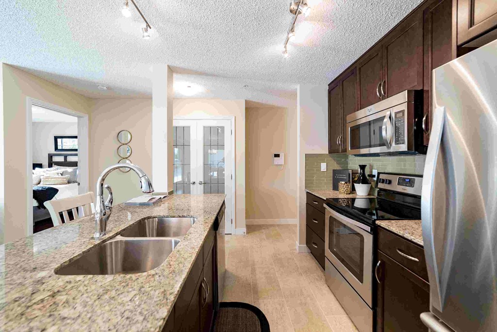 a kitchen with stainless steel appliances and granite counter tops