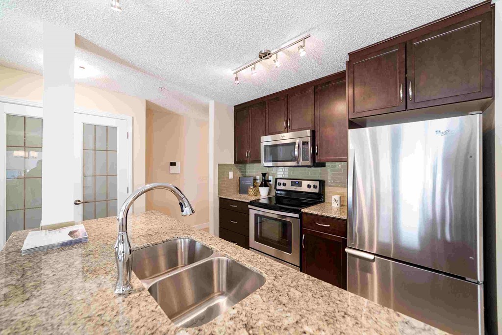 a kitchen with stainless steel appliances and granite counter tops