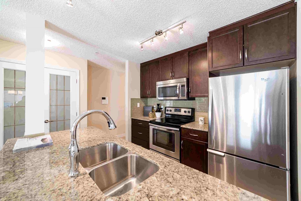 a kitchen with stainless steel appliances and granite counter tops