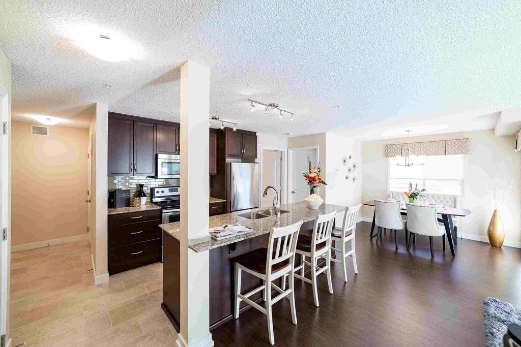 a kitchen and dining room with a table and chairs