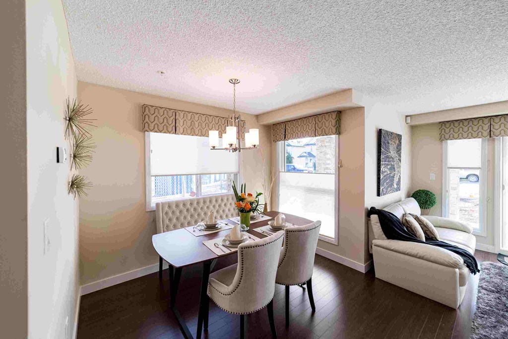 an image of a dining room with a table and chairs
