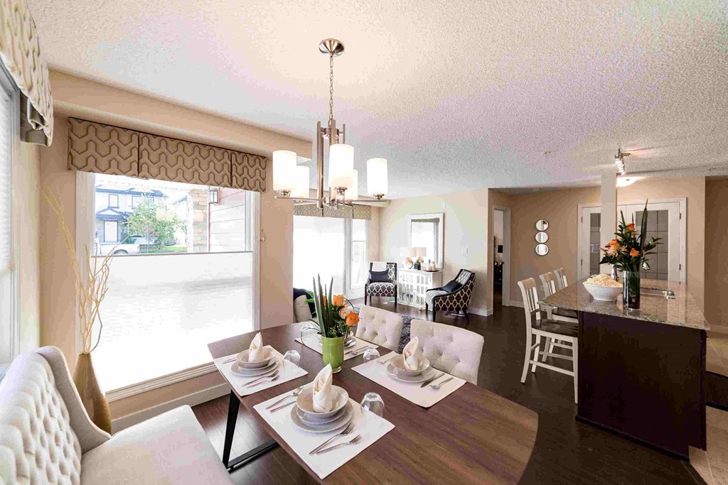 a view of the dining room and living room from the kitchen