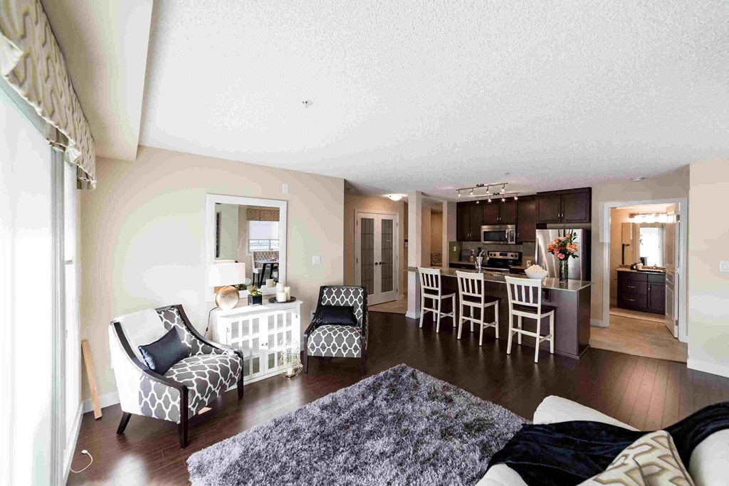 a view of a living room with a kitchen and a dining room