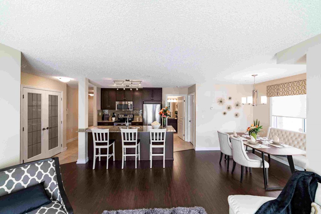 a view of the living room and dining room from the kitchen of a house