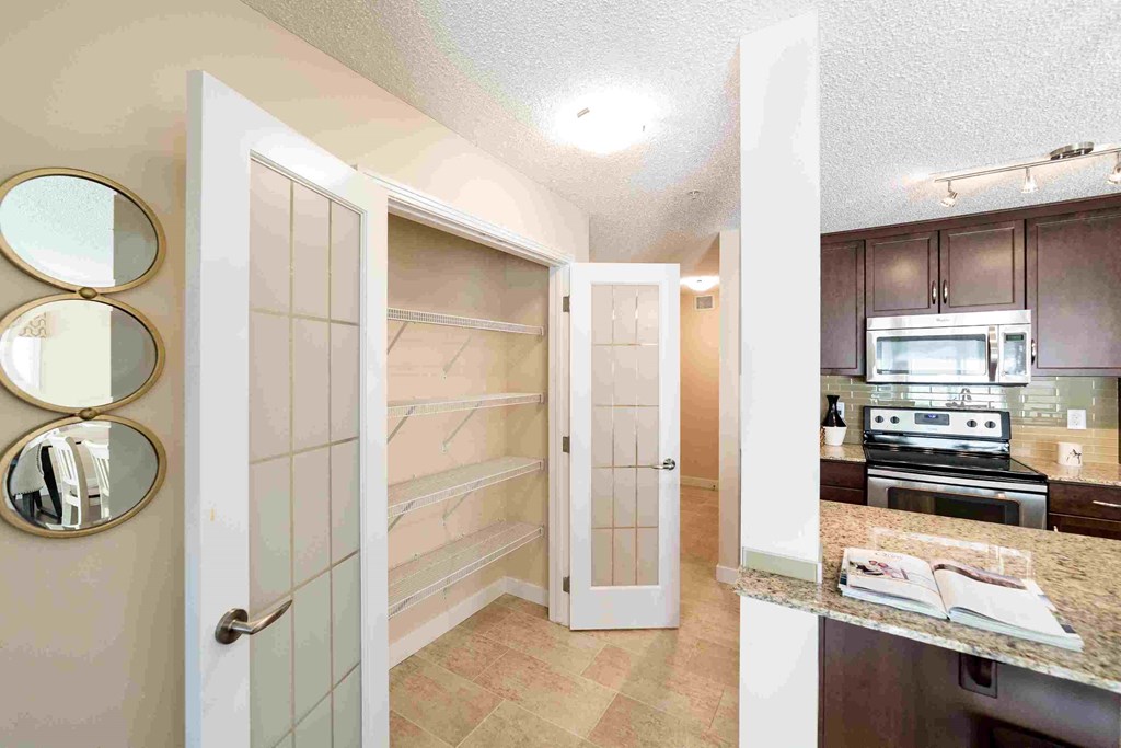 a kitchen with stainless steel appliances and a walk in closet