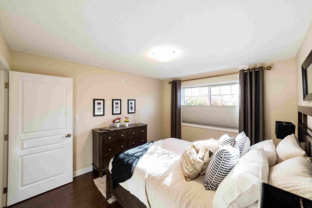 a bedroom with a bed and a dresser