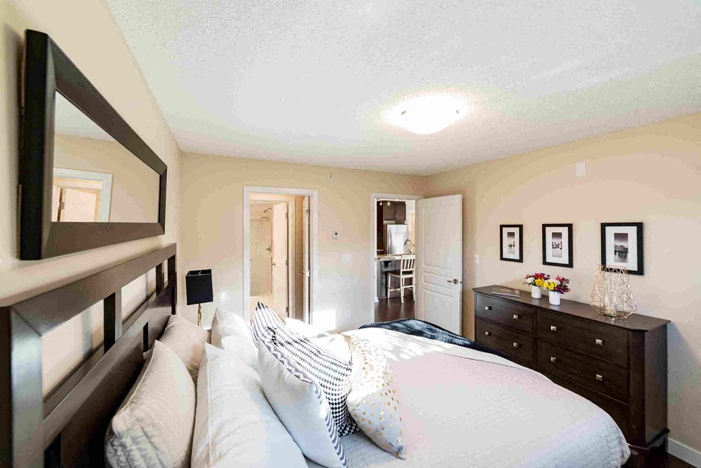 a bedroom with a bed and a dresser