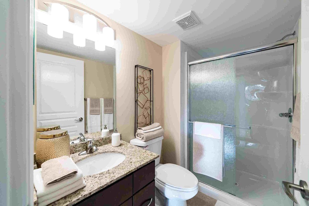 a bathroom with a sink toilet and a shower