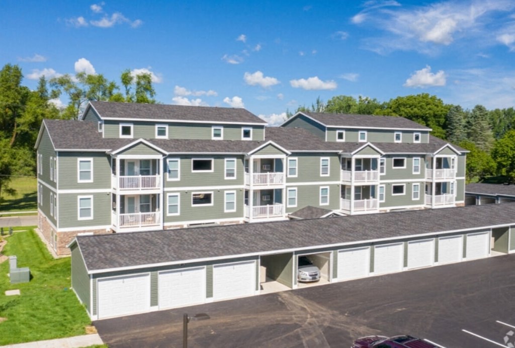 an aerial view of an apartment building with a parking lot