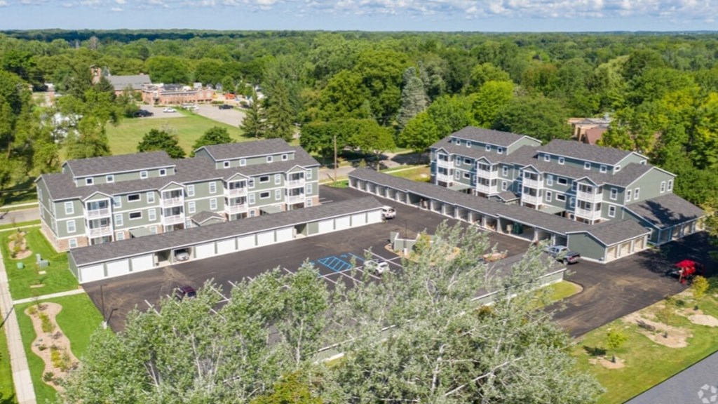 an aerial view of an apartment complex surrounded by trees