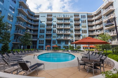Radius at the Banks Apartments for Rent in Cincinnati, OH Resident Outdoor Pool and Sundeck with Lounge Seating, Firepit, and Grilling Areas