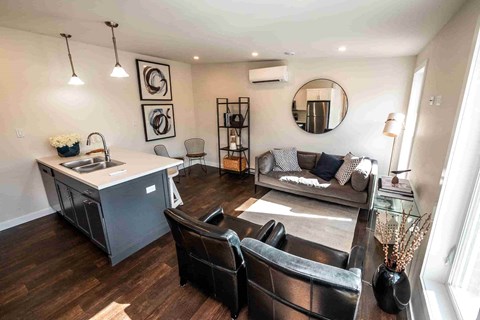 an open living room with a kitchen and a couch