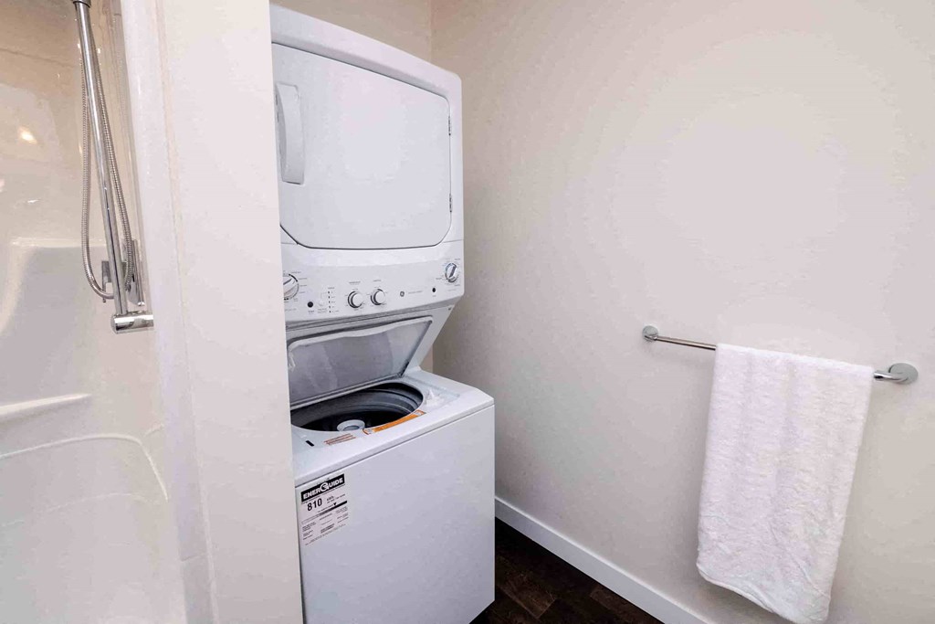 a washer and dryer in a bathroom in a hotel room