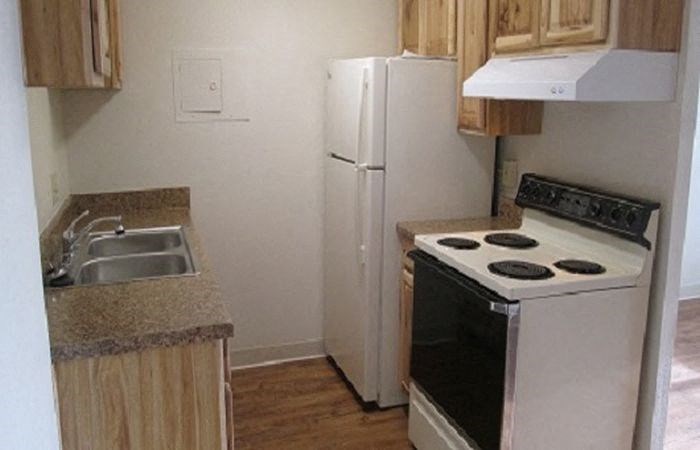 a small kitchen with a stove and a refrigerator