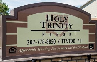 a sign for the holy trinity manor