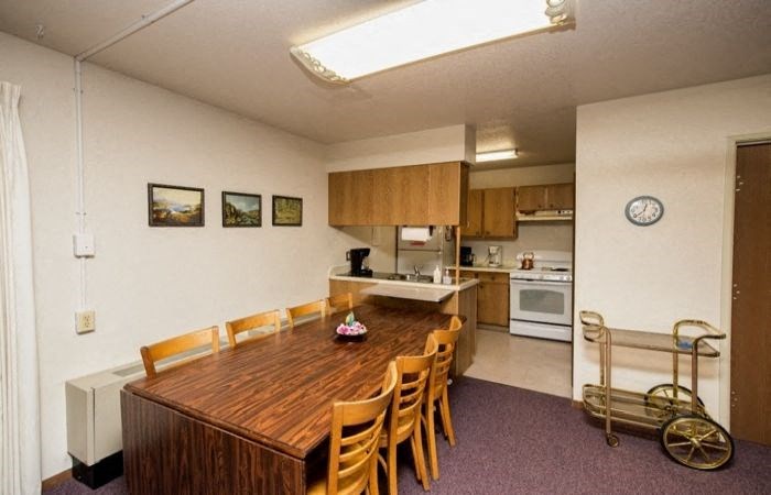 a kitchen and a dining room with a table and chairs