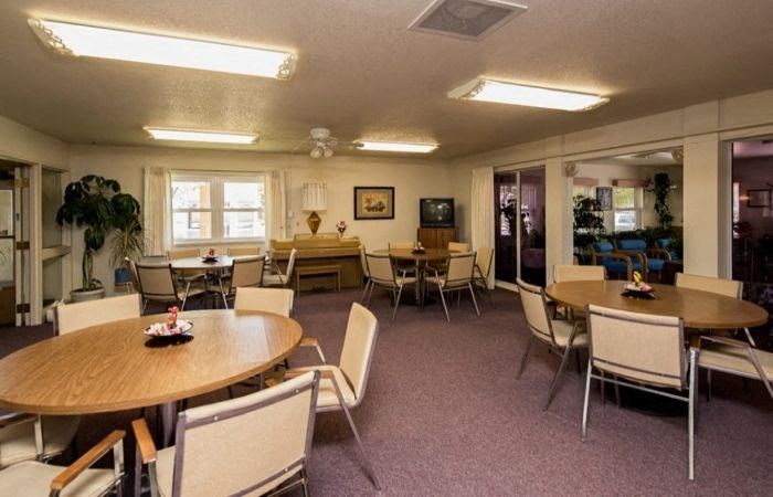 a dining room with tables and chairs and chairs