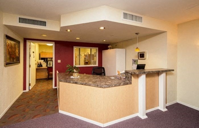 a hotel lobby with a counter and a reception desk
