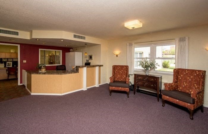 a living room with two chairs and a counter