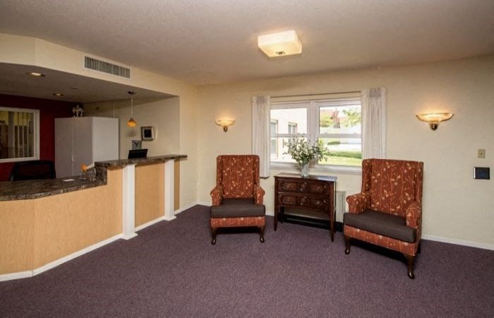 a living room with two chairs and a counter