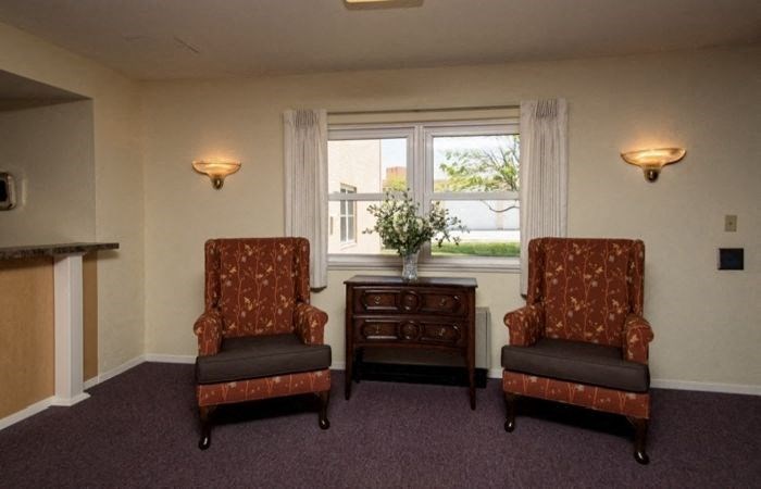 a living room with two chairs and a table