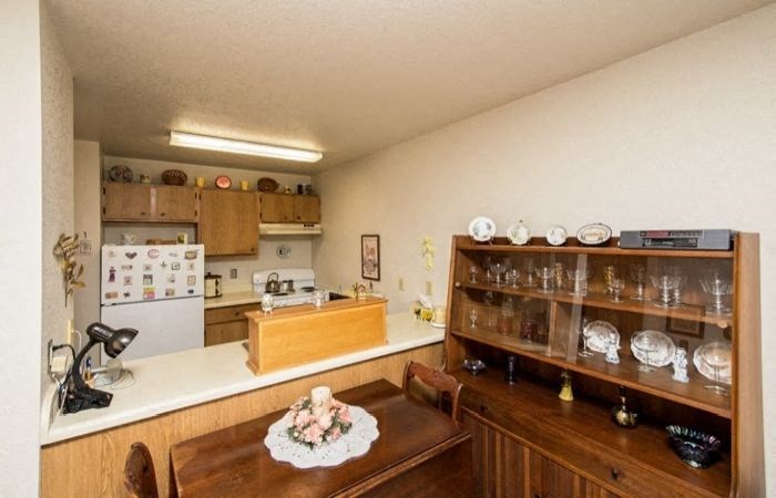 a kitchen with a dining room table and a refrigerator
