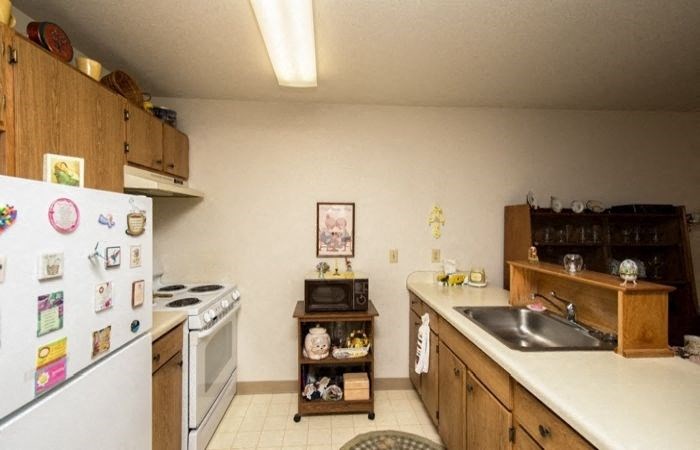 a kitchen with a stove refrigerator and a sink