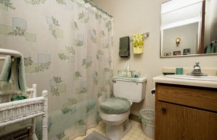 a bathroom with a toilet and a sink and a shower