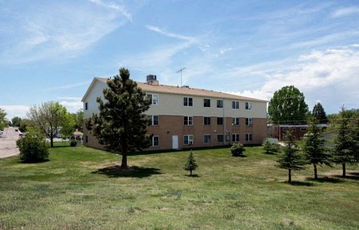 a large brick building with trees in front of it