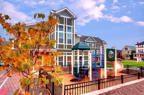 a playground in front of an apartment building