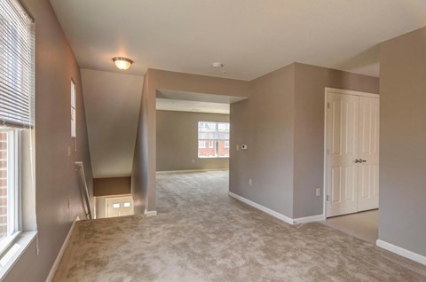 the living room and dining room of an empty house