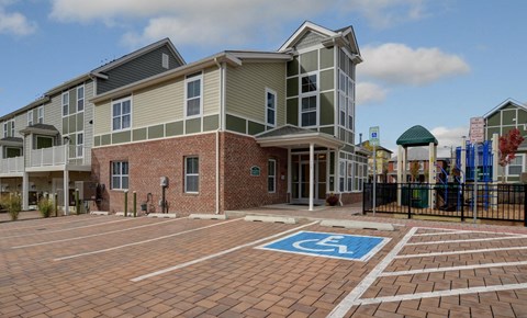 an empty parking lot in front of an apartment building