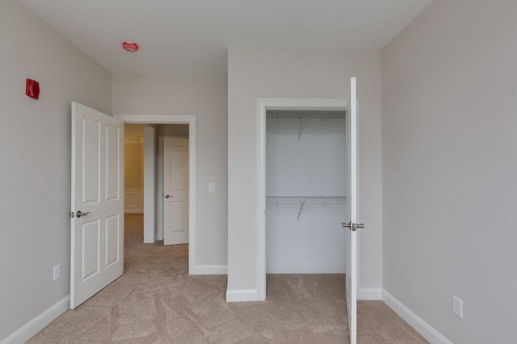 a bedroom with a closet and an open door