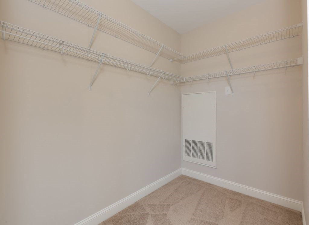 an empty room with white walls and a white closet
