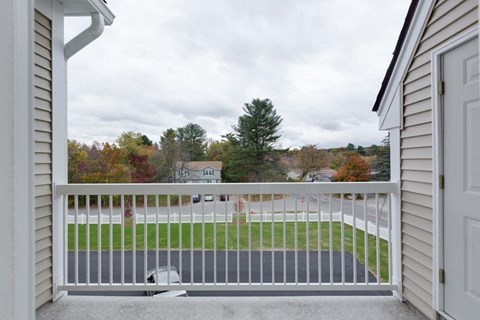 the view from the balcony of a home with a white fence