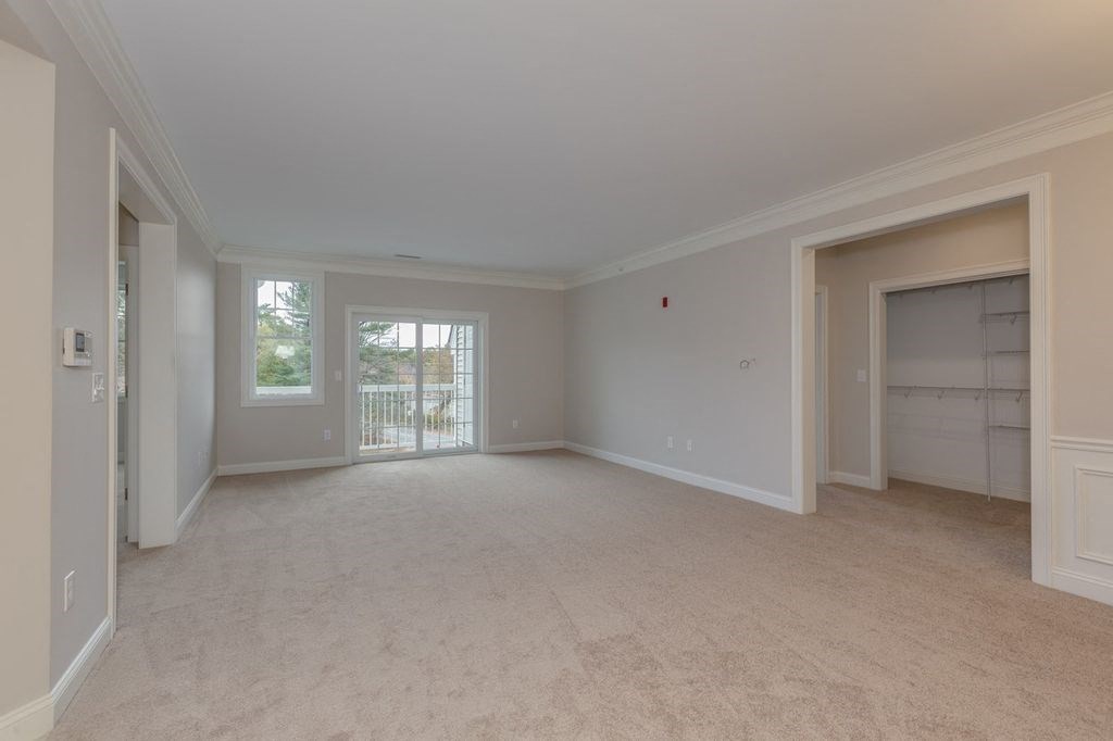 an empty living room with a garage door