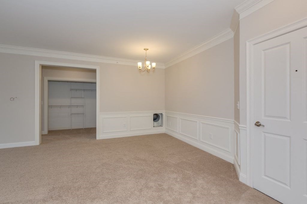 an empty living room with white walls and white doors
