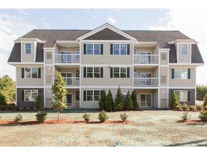 a large apartment building with a yard in front of it